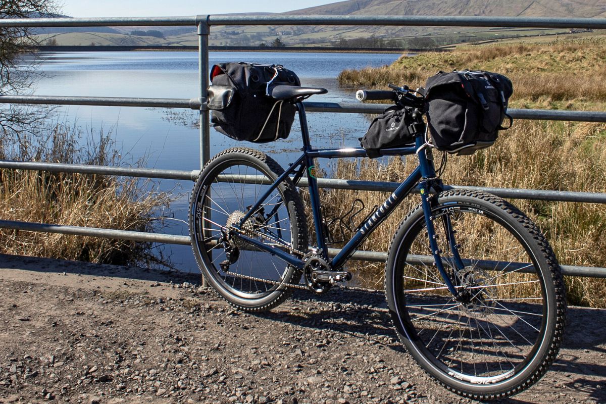 Bike leaning again fence with water in background